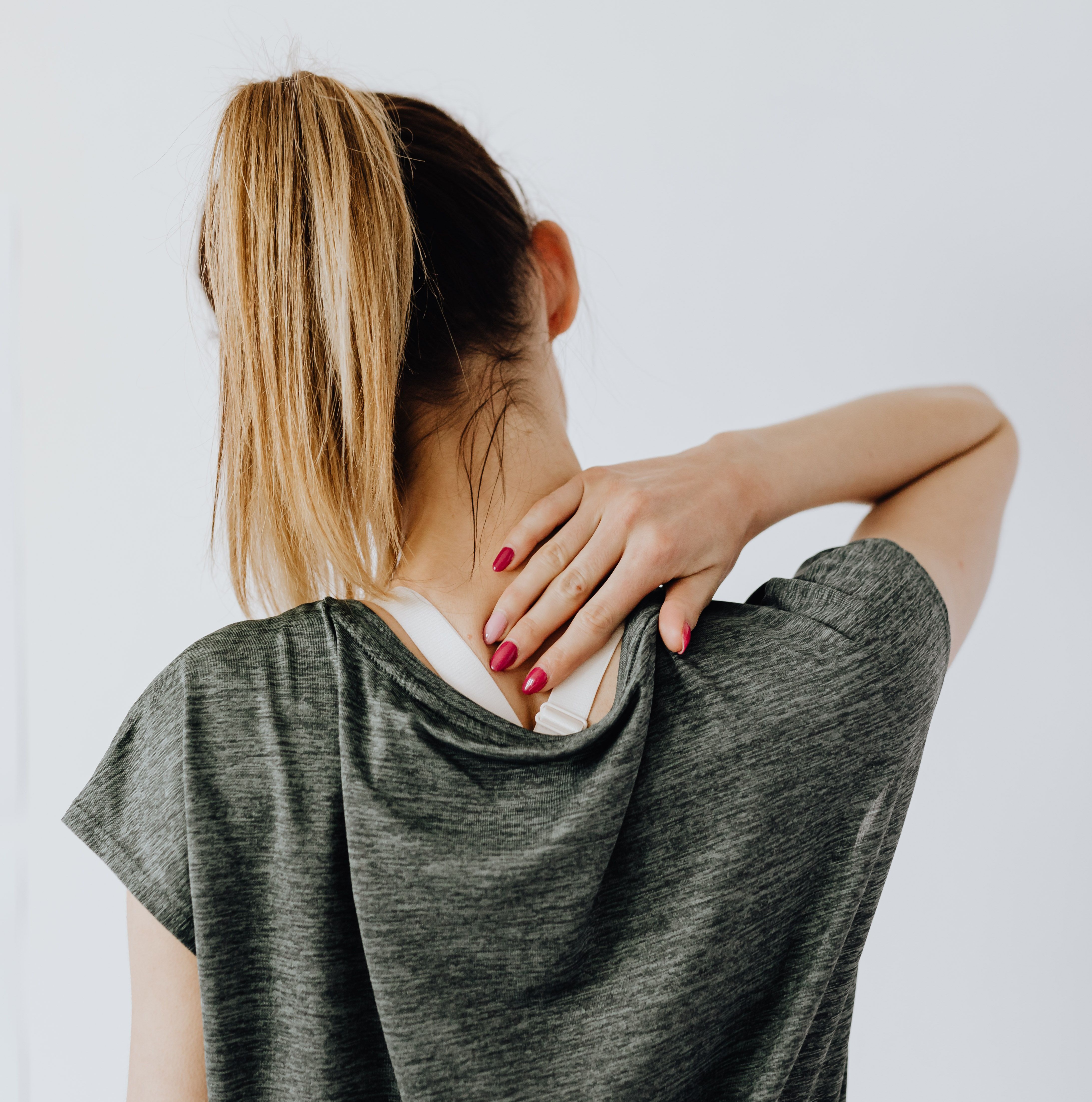 Woman touching the back of her neck